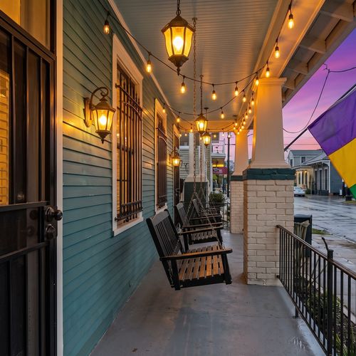 Cozy front porch entry w/ character-filled details & a warm, welcoming feel.