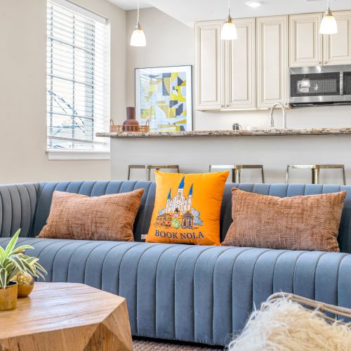 Plush blue sofa with a little Book NOLA welcome