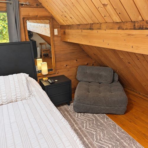LOFT (THIRD FLOOR):  The home has a very cute top floor loft area with a king size bed, fold-out bed, chairs, nightstands, lamps, mirror, dresser, clothing rack, and a television.