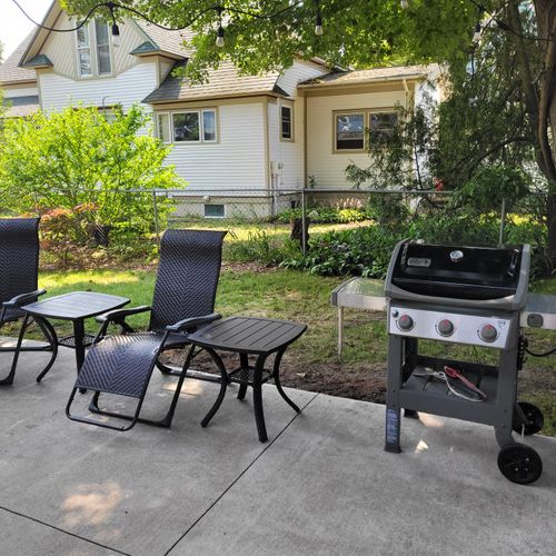 EXTERIOR: The cute outdoor patio of the main house with a grill for guest use