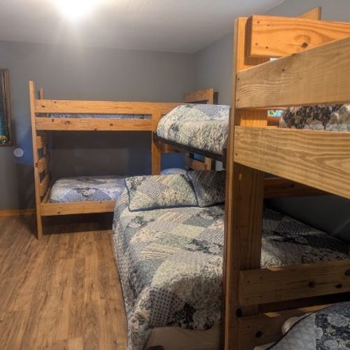 MAIN ROOM:  The main room, which features 6 beds (5 twins and 1 double), a small dining table, and a small sink / kitchenette.