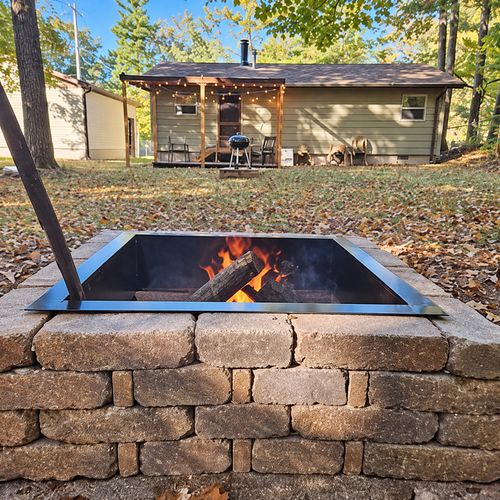 EXTERIOR:  The backyard highlighting the backyard firepit, charcoal grill, and backyard deck.