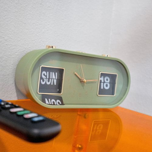 Fun retro flip clock & TV remote close at hand on the bright nightstand