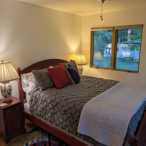 BEDROOM #2 (SECOND FLOOR):  Features a queen-size bed, nightstands, lamps, ceiling fan, dresser, mirror, and closet.