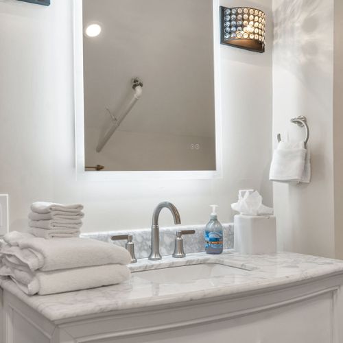 Backlit mirror and fluffy towels at the ready