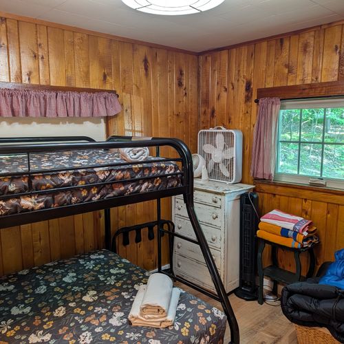 BEDROOM #2: Includes a twin on full bunk bed, a dresser, and a mirror.