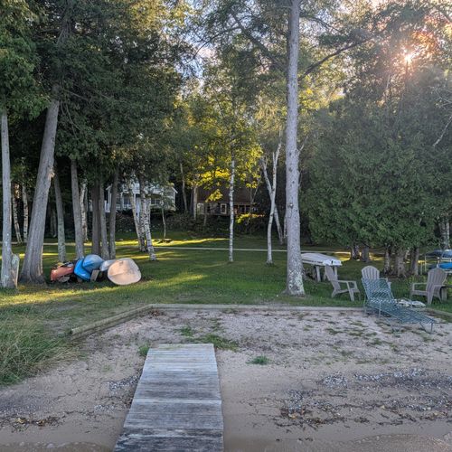 OVERVIEW:  The private beach, bonfire ring, and the kayaks and paddleboards that are available for guest usage.