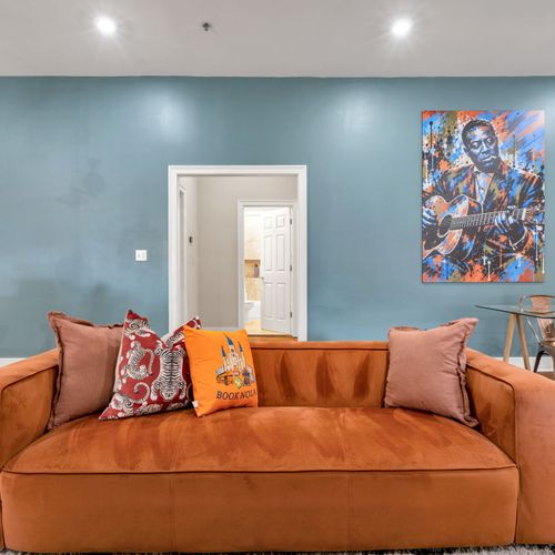 Velvet sofa against a calming blue wall