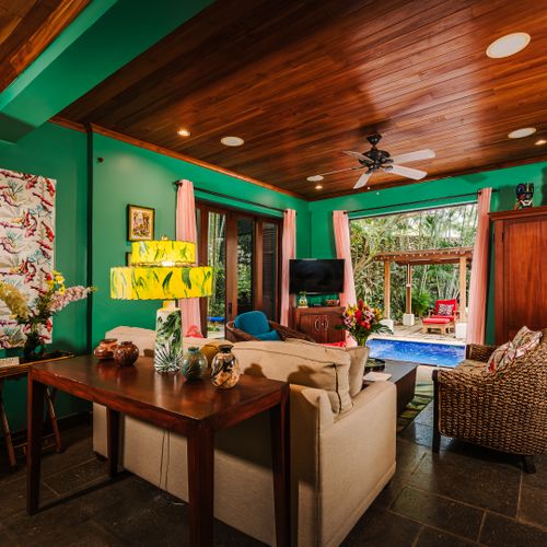 Open-concept lounge with integrated living and dining spaces at this luxury vacation rental in Langosta, near Tamarindo. Flowing layout connects indoor comfort to outdoor pool views. Perfect for family vacation, gatherings and entertaining in style.