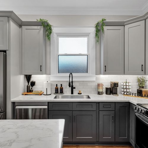 Rinse up by the sunny window over the sink, surrounded by fresh greenery & gray cabinetry
