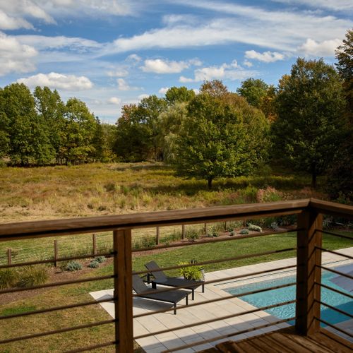A view of the meadow and pool from the second story deck of the guest house.