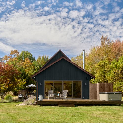 Looking towards the hot tub deck and outdoor shower, with sliding doors that enter into the main house living room.