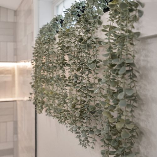 A lush wall of greenery brings a fresh, calming touch to the bathroom