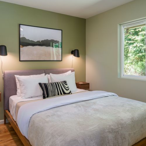 Rest easy in this tranquil bedroom with plush bedding and peaceful woodland views.