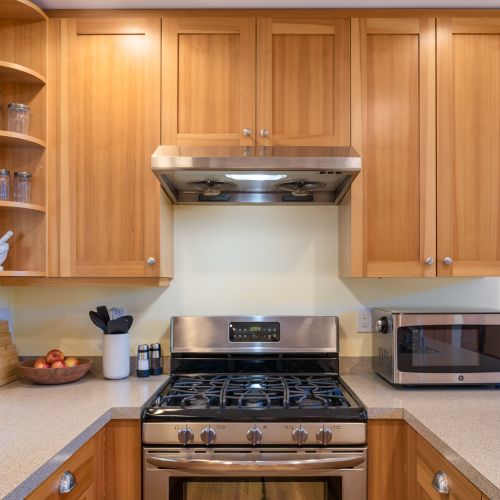 Cook with ease in the fully equipped kitchen featuring a gas range, microwave, cookware, utensils, and plenty of counter space for preparing meals together.