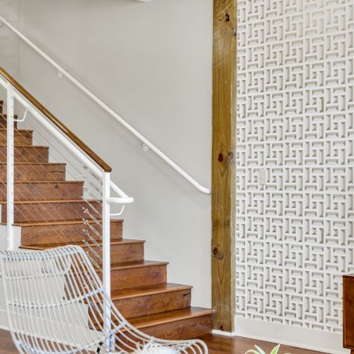 Rich hardwood staircase with modern railing