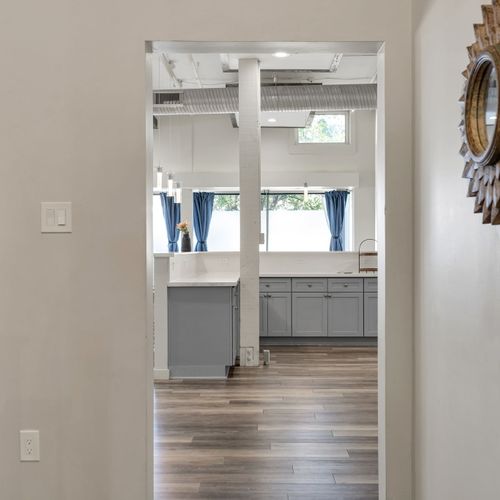 Hallway peek into the bright kitchen