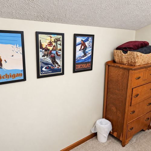 BEDROOM #2 (FIRST FLOOR):  Features a twin-on-twin bunk bed, nightstand, closet, dresser, and mirror.