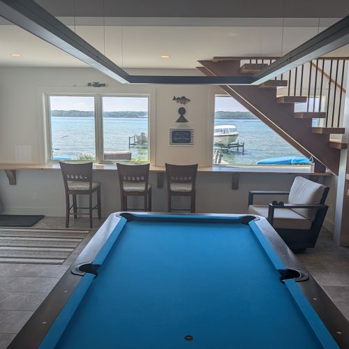 GAME ROOM (FIRST FLOOR):  The home has an amazing game room on the first floor that features a deluxe championship pool table as well as a wet bar and great views of Crystal Lake!