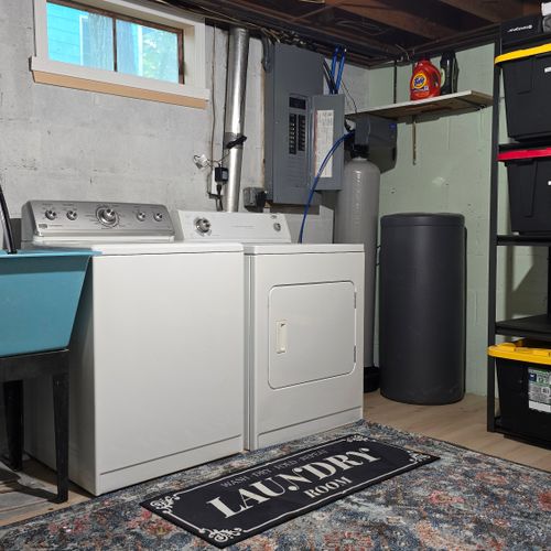 LAUNDRY ROOM (LOWER LEVEL):  Very convenient laundry room with a washer, dryer, and laundry sink.