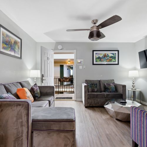 Bright living room w/ comfy seating & warm décor — the perfect spot to unwind after a day out.