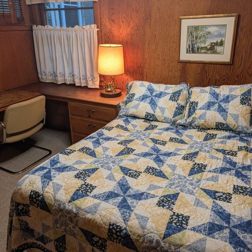 BEDROOM #2 (MAIN FLOOR):  Features a queen-size bed, desk, and closet.
