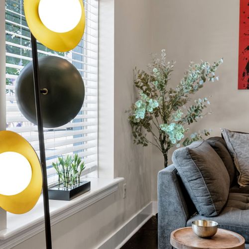 Mod floor lamp beside a sunny window