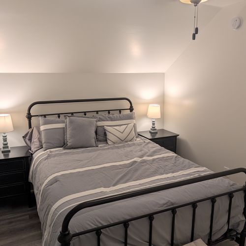 BEDROOM #1 (SECOND FLOOR):  Features a queen-size bed, nightstands, lamps, dresser, mirror, closet, and ceiling fan.