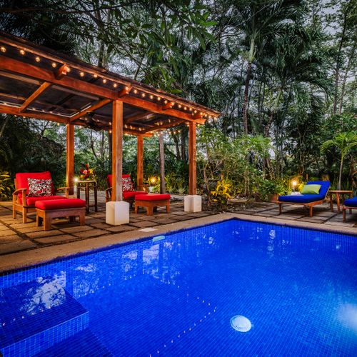Pool view with cozy bungalow at this Langosta rental near Tamarindo. Ideal surf retreat for wave chasers and beach lovers. Lounge by the water after morning sessions, plan next day's adventures, and enjoy pure coastal vacation vibes.