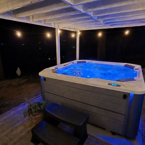 EXTERIOR:  The incredible new 6-person hot tub, with a great view of Bass Lake from the hot tub!
