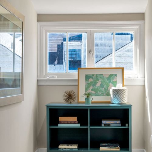 Sunny window nook with a teal bookshelf