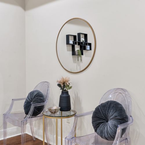 Velvet chairs and a playful round shelf