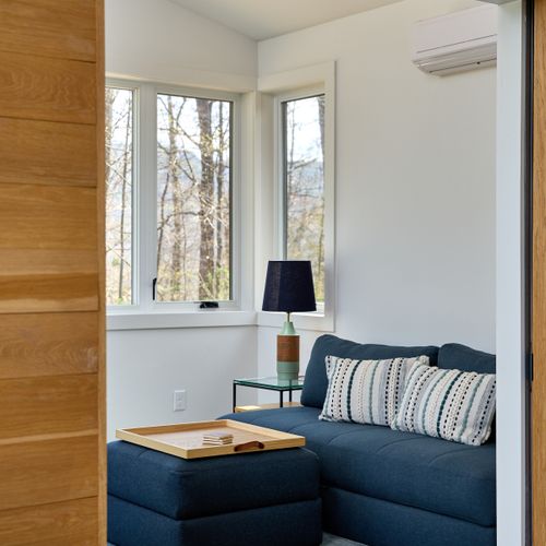 Looking into the work space in the pool house, with a sleeper sofa that allows for additional accommodation.