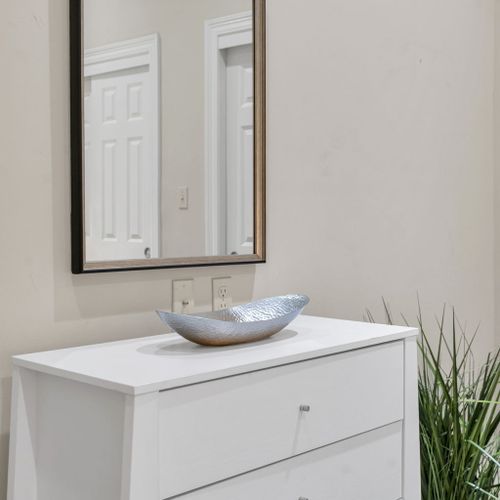 Crisp white dresser with sculptural accents
