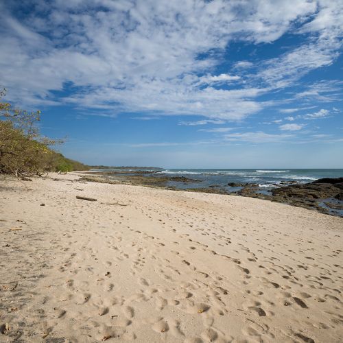 Playa Langosta - white sand, rocky points, soft surf at sunset, all from your gate.