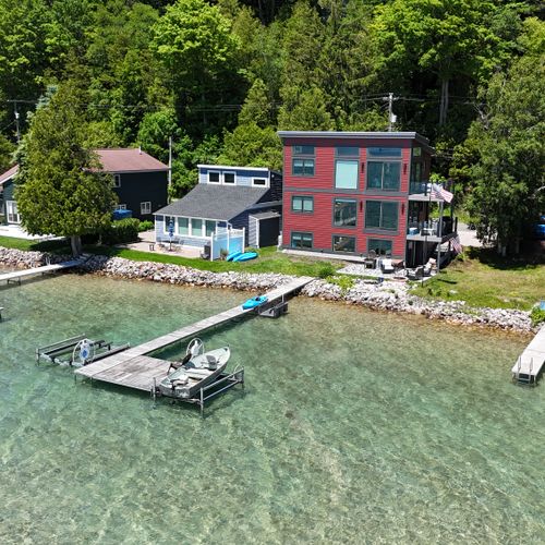 EXTERIOR:  Aerial photo of Eagles Landing, the backyard, the deck, the private dock, and the kayaks.  (Kayaks are included with rental, but motor boats are not.)