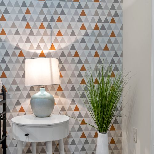 Geometric wallpaper and a soft glowing lamp