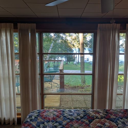 BEDROOM #1 (MAIN FLOOR):  Features a great view of Crystal Lake, queen-size bed, closet, dresser, and a televison.