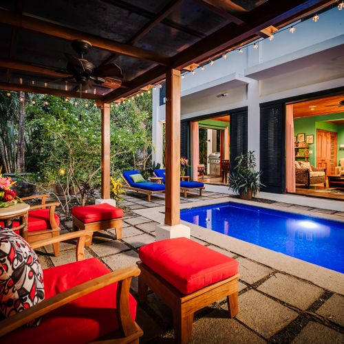 Cozy bungalow lounge area overlooking the pool, open-concept house, and living room interior at this Langosta luxury vacation rental. Tropical garden views, fine art decor, peaceful atmosphere, perfect for indoor-outdoor coastal living in Tamarindo.