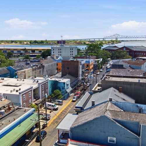Expansive aerial view stretching across the rooftops of New Orleans.