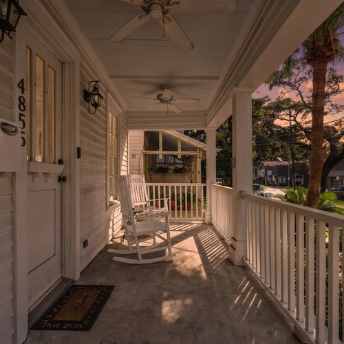 Charming front porch w/ seating — perfect for a slow morning or evening unwind.