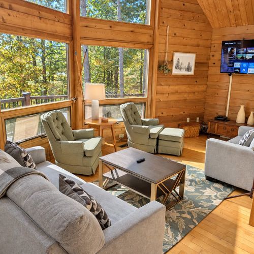 LIVING ROOM (SECOND FLOOR):  The home has a gorgeous living room with a sofa, loveseat, chairs, coffee table, and large screen television.