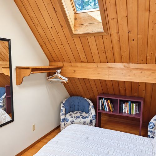 LOFT (THIRD FLOOR):  The home has a very cute top floor loft area with a king size bed, fold-out bed, chairs, nightstands, lamps, mirror, dresser, clothing rack, and a television.