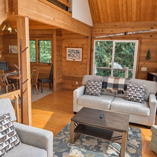 LIVING ROOM (SECOND FLOOR):  The home has a gorgeous living room with a sofa, loveseat, chairs, coffee table, and large screen television.