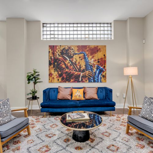 Velvet sofa beneath a jazzy saxophone mural