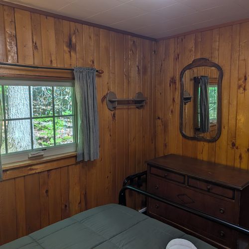 BEDROOM #1:  Includes a queen-size bed, nightstands, lamps, a dresser, and a mirror.