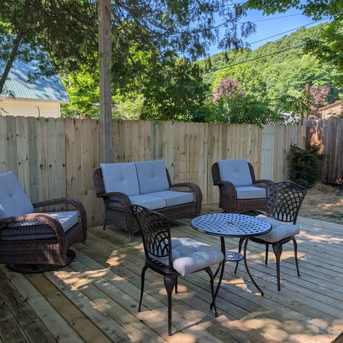 EXTERIOR: The cute fenced-in backyard of the apartment with plenty of seating. Fun and relaxing times found here!