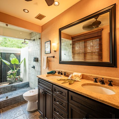 Elegant open concept bathroom with outdoor sink area surrounded by lush tropical gardens at a luxury Playa Langosta vacation rental in Tamarindo, Costa Rica. Unique coastal design ideal for relaxing beach vacations and tropical living in your trip.