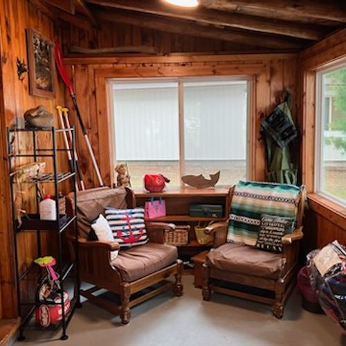 SUNROOM:  The home has a lovely sunroom with lots of seating and a great view of Van Etten Lake.
