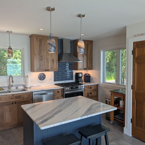 KITCHEN (SECOND FLOOR):  The home has a full kitchen with a kitchen island and all appliances, including a dishwasher.  There is also a great view of Crystal Lake from the ktichen!